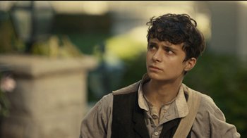 Movie still from “Anne with an E” (2017), created by Moira Walley-Beckett – A young man in a vest looking to his left; Close Up shot, Over the shoulder angle
