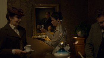 Movie still from “Anne with an E” (2017), created by Moira Walley-Beckett – A woman holding a tray of food and a glass of wine; Medium shot, Over the shoulder angle