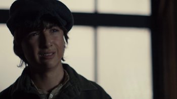 Movie still from “Anne with an E” (2017), created by Moira Walley-Beckett – A young man wearing a hat and a jacket in front of a window; Close Up shot, Over the shoulder angle