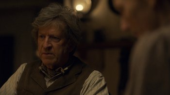 Movie still from “Anne with an E” (2017), created by Moira Walley-Beckett – An older man wearing a brown vest and a bow tie; Close Up shot, Over the shoulder angle