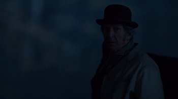 Movie still from “Anne with an E” (2017), created by Moira Walley-Beckett – An old man wearing a black hat and a coat; Close Up shot, Over the shoulder angle