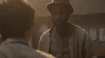 Movie still from “Anne with an E” (2017), created by Moira Walley-Beckett – A man wearing a hat is looking at another man; Close Up shot, Over the shoulder angle