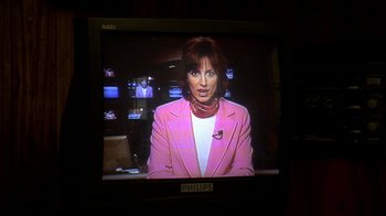 Movie still from “The Sopranos” (1999), created by David Chase – A woman in a pink jacket on a television screen; Close Up shot, High angle