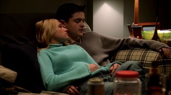 Movie still from “The Sopranos” (1999), created by David Chase – A man and a woman sitting on a couch together; Medium shot, Low angle