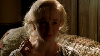 Movie still from “The Sopranos” (1999), created by David Chase – A woman with blonde hair is sitting on a couch; Close Up shot, High angle