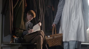 Movie still from “Anne with an E” (2017), created by Moira Walley-Beckett – A young man sitting on top of a wooden bench; Medium shot, High angle