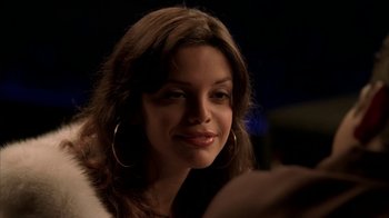 Movie still from “The Sopranos” (1999), created by David Chase – A person with a smile on their face; Close Up shot, Over the shoulder angle
