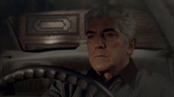 Movie still from “The Sopranos” (1999), created by David Chase – An older man sitting in the driver's seat of a car; Close Up shot, Low angle