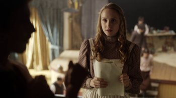 Movie still from “Anne with an E” (2017), created by Moira Walley-Beckett – A young woman holding a piece of paper in her hands; Medium shot, Over the shoulder angle