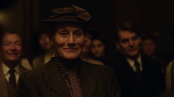 Movie still from “Anne with an E” (2017), created by Moira Walley-Beckett – An older woman wearing a hat in front of a group of people; Close Up shot, Over the shoulder angle