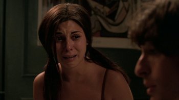 Movie still from “The Sopranos” (1999), created by David Chase – A young woman crying in a dark room; Close Up shot, Over the shoulder angle