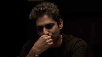 Movie still from “The Sopranos” (1999), created by David Chase – A man with his hand to his face; Close Up shot, High angle