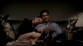 Movie still from “The Sopranos” (1999), created by David Chase – A man and a woman sitting next to each other on a couch; Medium shot, High angle