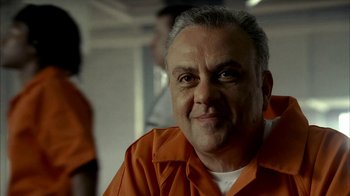 Movie still from “The Sopranos” (1999), created by David Chase – An older man in an orange prison uniform; Close Up shot, Low angle