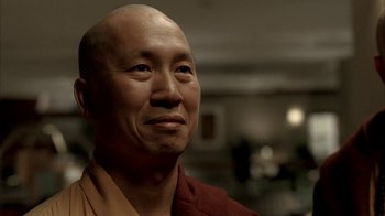 Movie still from “The Sopranos” (1999), created by David Chase – A man with a shaved head and a bald head is smiling; Close Up shot, Low angle