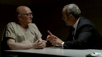 Movie still from “The Sopranos” (1999), created by David Chase – Two men sitting at a table talking to each other; Medium shot, Over the shoulder angle