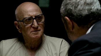 Movie still from “The Sopranos” (1999), created by David Chase – An older man wearing glasses talking to a younger man; Close Up shot, Over the shoulder angle