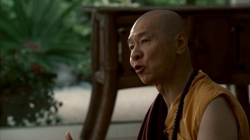 Movie still from “The Sopranos” (1999), created by David Chase – A man in a yellow shirt and a brown robe; Close Up shot, Over the shoulder angle