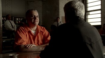 Movie still from “The Sopranos” (1999), created by David Chase – A man in an orange shirt is talking to another man in an orange shirt; Medium shot, Over the shoulder angle