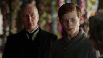 Movie still from “Anne with an E” (2017), created by Moira Walley-Beckett – A man and a woman standing next to each other; Medium shot, Over the shoulder angle