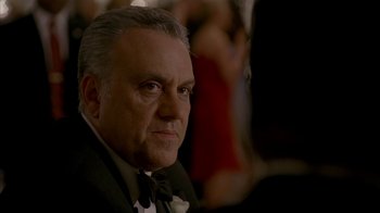 Movie still from “The Sopranos” (1999), created by David Chase – An older man wearing a suit and bow tie; Close Up shot, Low angle