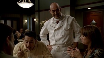 Movie still from “The Sopranos” (1999), created by David Chase – A man in a chef's outfit standing at a table with two other men; Medium shot, Over the shoulder angle