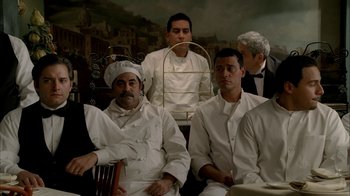 Movie still from “The Sopranos” (1999), created by David Chase – A group of chefs sitting next to each other; Medium shot, Low angle