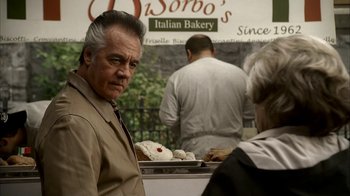 Movie still from “The Sopranos” (1999), created by David Chase – An older man standing in front of a bakery counter; Close Up shot, Over the shoulder angle