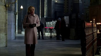 Movie still from “The Sopranos” (1999), created by David Chase – A woman in a pink coat standing in a building; Medium shot, Low angle