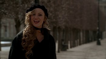 Movie still from “The Sopranos” (1999), created by David Chase – A woman with long blonde curly hair wearing a beret; Close Up shot, Low angle
