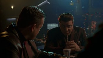 Movie still from “The Sopranos” (1999), created by David Chase – Two men sitting at a table in front of each other; Medium shot, Over the shoulder angle