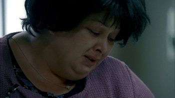 Movie still from “The Sopranos” (1999), created by David Chase – A person wearing a purple sweater; Close Up shot, High angle