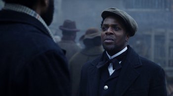 Movie still from “Anne with an E” (2017), created by Moira Walley-Beckett – A man wearing a hat and a tie; Close Up shot, Over the shoulder angle