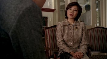 Movie still from “The Sopranos” (1999), created by David Chase – A woman sitting in front of a man in a chair; Close Up shot, Over the shoulder angle