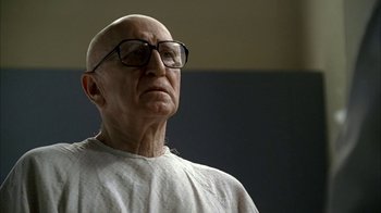 Movie still from “The Sopranos” (1999), created by David Chase – An old man wearing glasses looking up at something; Close Up shot, Low angle