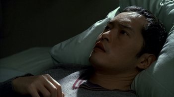 Movie still from “The Sopranos” (1999), created by David Chase – A man laying in bed with his head resting on a pillow; Close Up shot, High angle