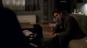 Movie still from “The Sopranos” (1999), created by David Chase – A man sitting in front of a computer desk; Medium shot, Over the shoulder angle