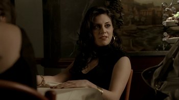 Movie still from “The Sopranos” (1999), created by David Chase – A woman sitting at a dinner table with her hand on her chin; Close Up shot, Over the shoulder angle