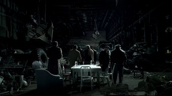 Movie still from “The Sopranos” (1999), created by David Chase – A group of people standing around a table in the dark; Wide shot, High angle