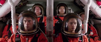 Movie still from “The Space Between Us” (2017), directed by Peter Chelsom – A group of people in spacesuits are reflected in a mirror; Medium shot, Overhead angle