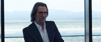 Movie still from “The Space Between Us” (2017), directed by Peter Chelsom – A person wearing a suit and glasses; Close Up shot, Over the shoulder angle