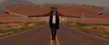 Movie still from “The Space Between Us” (2017), directed by Peter Chelsom – A man walking down the middle of the street; Wide shot, Low angle