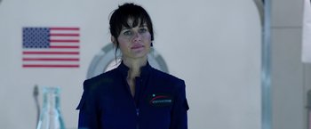 Movie still from “The Space Between Us” (2017), directed by Peter Chelsom – A woman in a blue jacket standing in front of a wall; Close Up shot, Over the shoulder angle