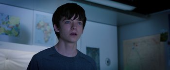 Movie still from “The Space Between Us” (2017), directed by Peter Chelsom – A young man with blue eyes stares into the distance; Close Up shot, Over the shoulder angle