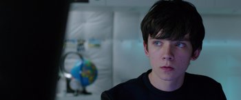 Movie still from “The Space Between Us” (2017), directed by Peter Chelsom – A young man with blue eyes stares at the camera; Close Up shot, Over the shoulder angle