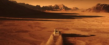 Movie still from “The Space Between Us” (2017), directed by Peter Chelsom – A truck is driving through the desert on a sunny day; Extreme Wide shot, High angle