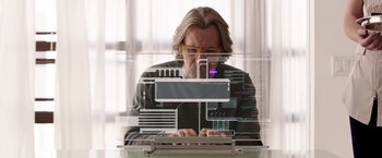 Movie still from “The Space Between Us” (2017), directed by Peter Chelsom – A man sitting in front of an open laptop computer; Medium shot, Low angle