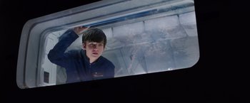 Movie still from “The Space Between Us” (2017), directed by Peter Chelsom – A man standing in front of a window; Medium shot, Low angle