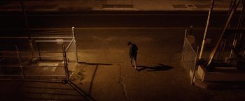 Movie still from “The Space Between Us” (2017), directed by Peter Chelsom – A person walking down a street at night; Extreme Wide shot, High angle