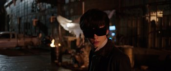 Movie still from “The Space Between Us” (2017), directed by Peter Chelsom – A man wearing a black mask standing in the dark; Close Up shot, Over the shoulder angle